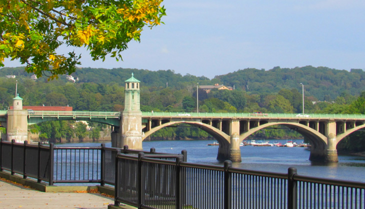 City of Haverhill A pleasant town decorated with foliage and a bridge over water