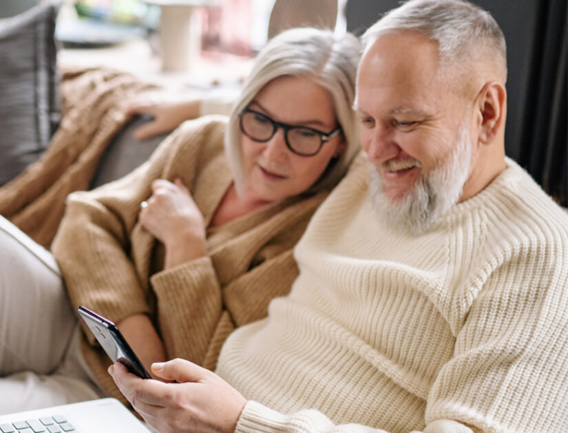 Peter and his wife watching smartphone Peter and his wife watching smartphone